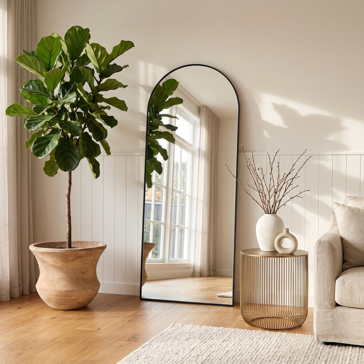 Antique terracotta Lucinda pot styled with lush indoor plant by arched full-length mirror