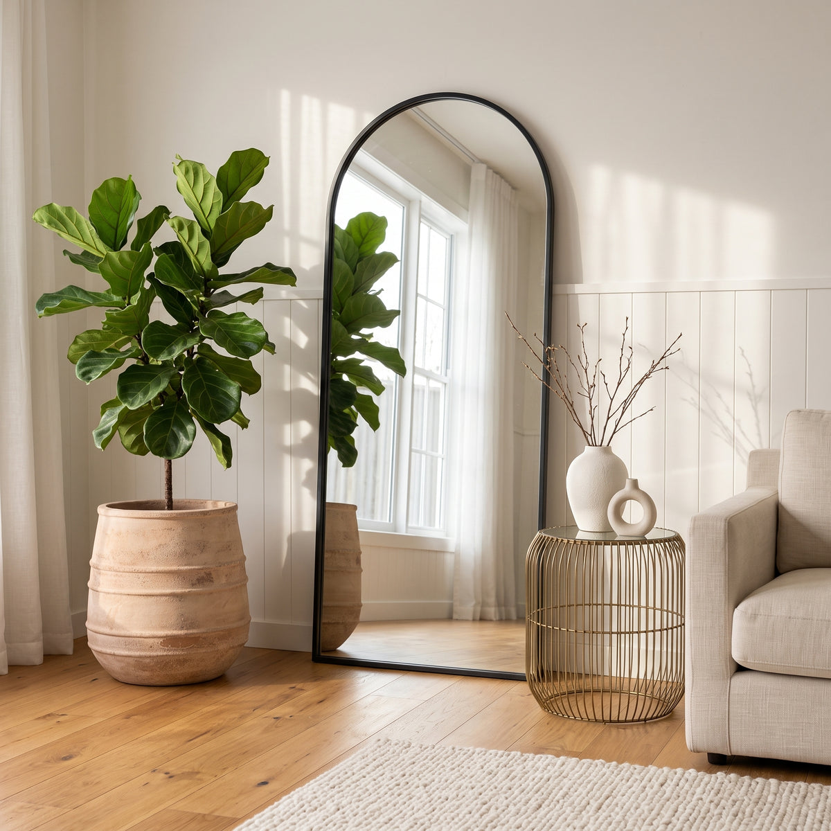 Large antique terracotta belly pot styled with fiddle leaf fig next to arched mirror