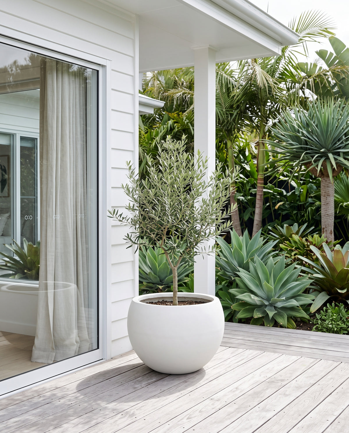 Pure white Asher moon planter with potted greenery on Queenslander timber verandah