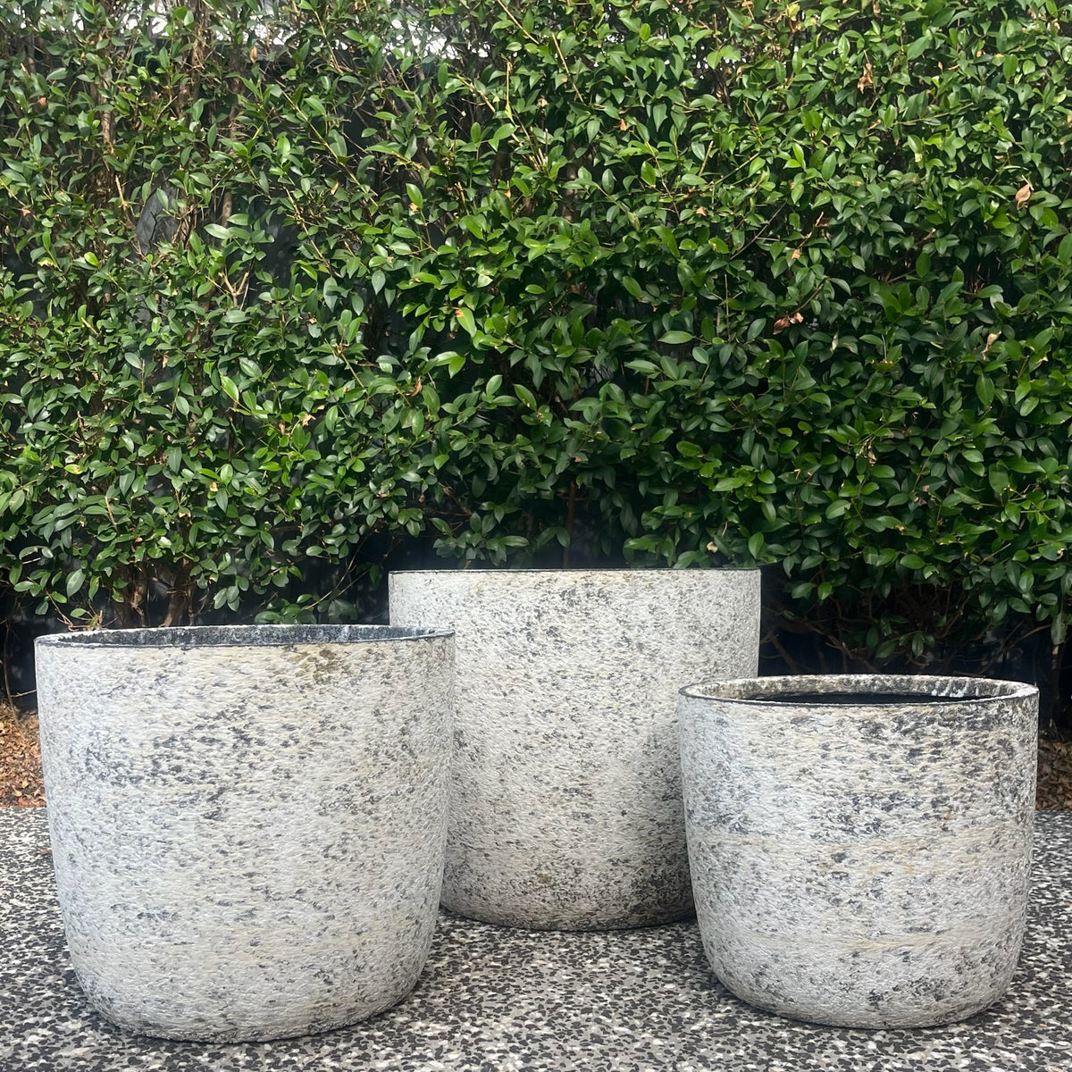 Cluster of textured Atlantic White Prague egg pots highlighting curved silhouette