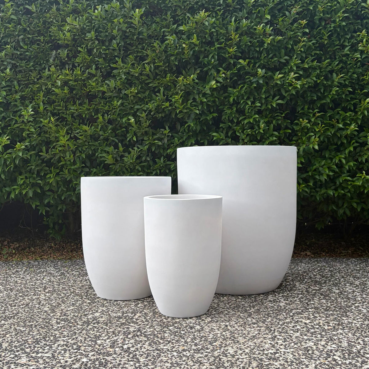 Chambers pure white lightweight U-pots cluster displayed outdoors on gravel