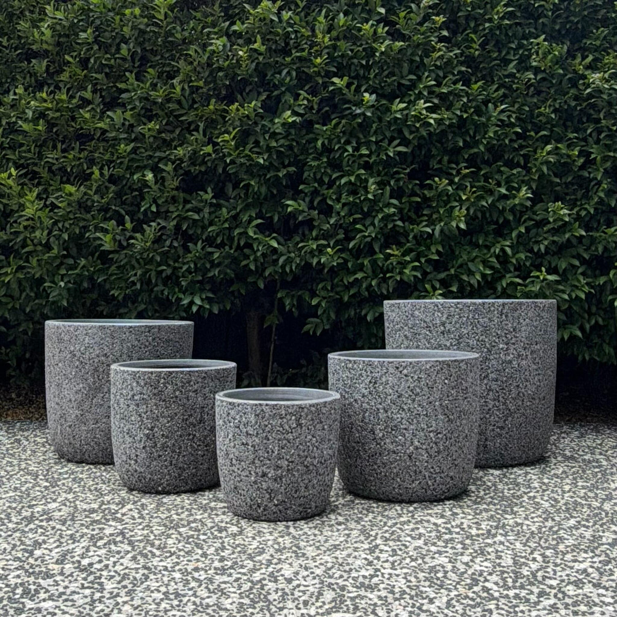 Prague Grey Pebble textured egg planters set of five sizes displayed on gravel