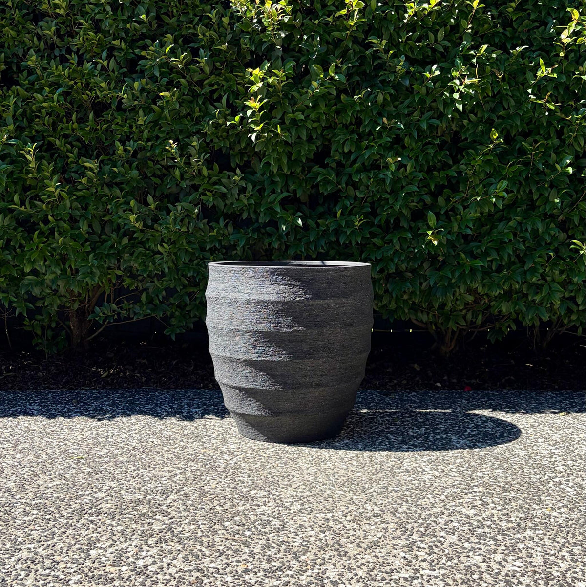 Single Horizons textured black egg planter highlighting horizontal ribbed surface