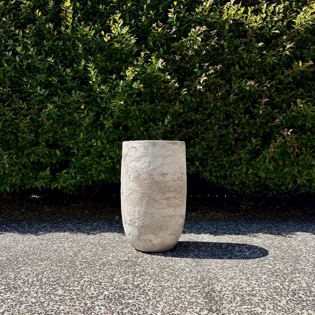 Single White Pietra tall U-pot planter highlighting stone texture