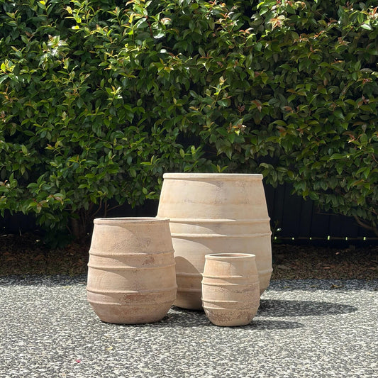 Antique terracotta belly planters trio set with ring detailing on gravel