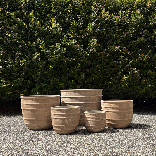 Antique terracotta Olympic pots set of five sizes displayed outdoors on gravel