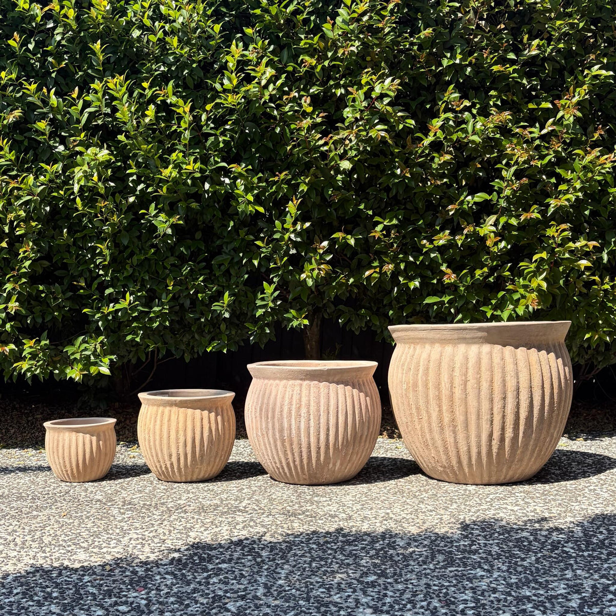 Antique terracotta Palermo threads belly planters four-pot set on outdoor gravel